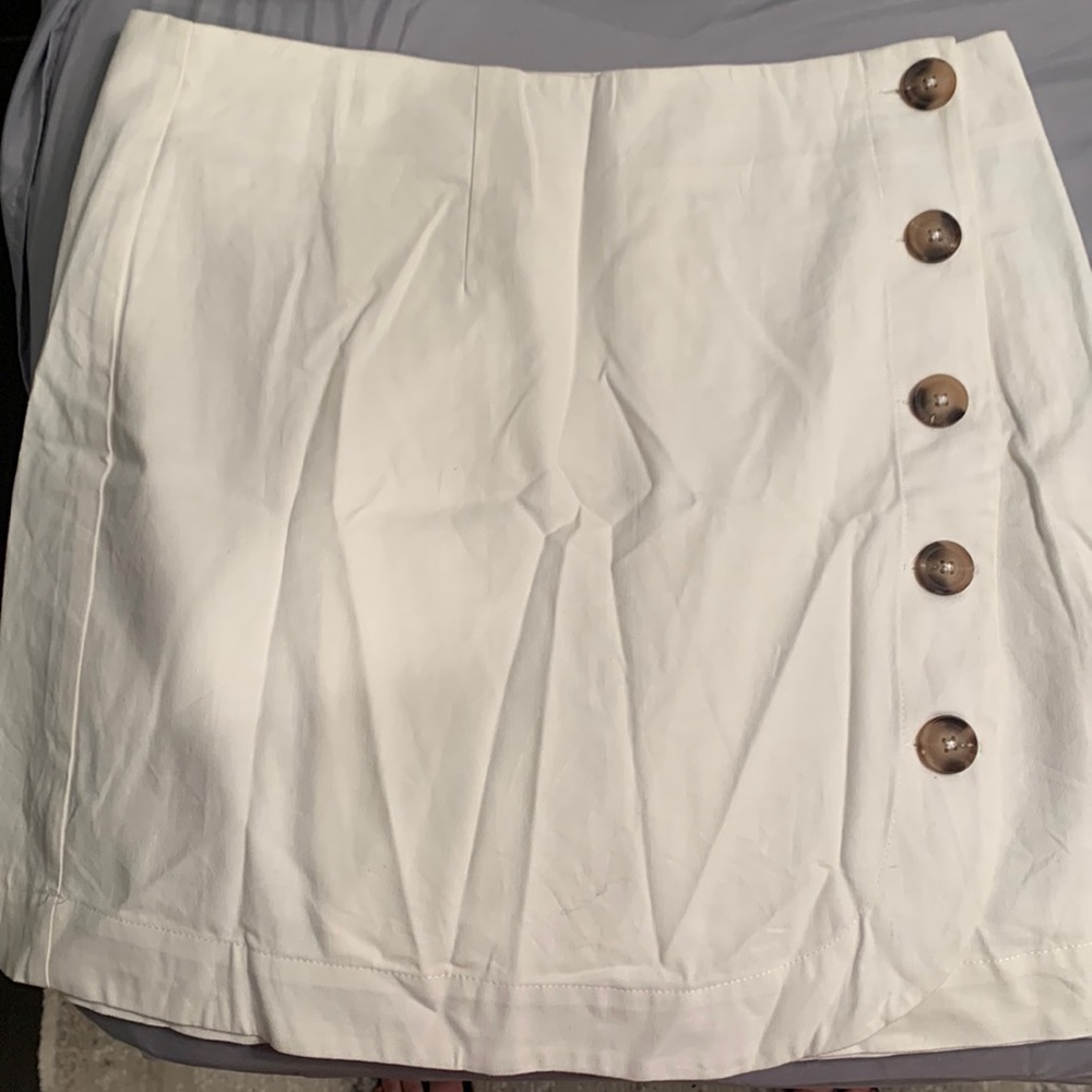 White skirt with brown buttons